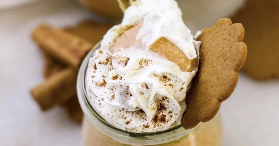 pumpkin pot de creme topped with whipped cream and ginger snaps