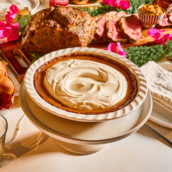 steam baked pumpkin pie topped with whipped cream