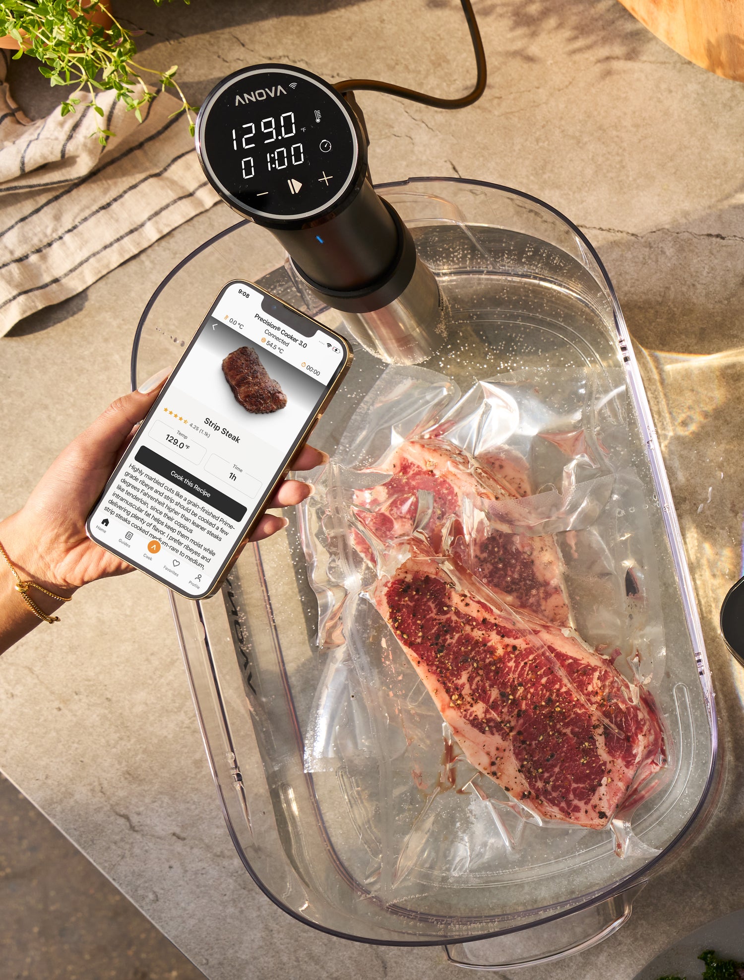 using a phone to set time and temp for cooking strip steaks in a sous vide water bath