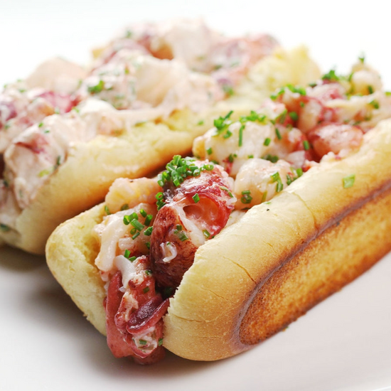 Maine-style lobster rolls with mayonnaise on a white plate