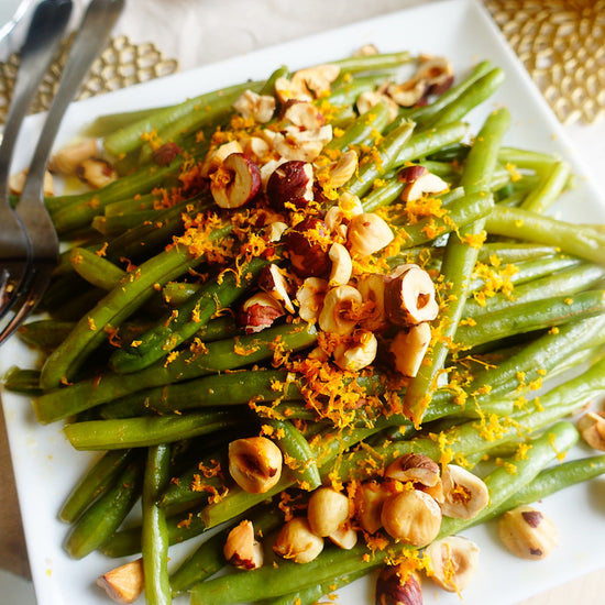 green beans topped with hazelnuts and orange zest