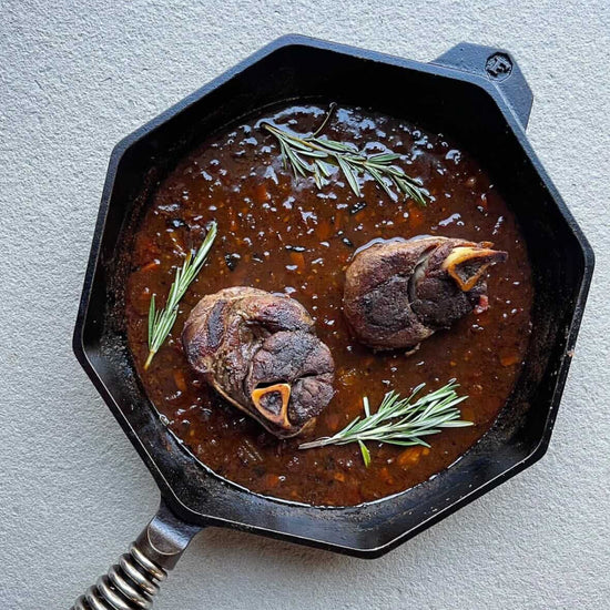 venison osso buco in a cast iron skillet